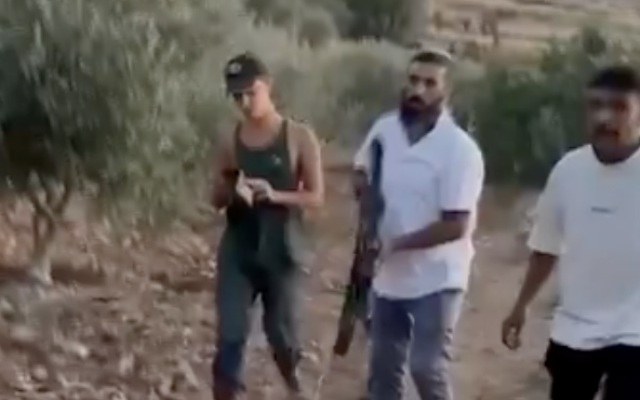 Armed settlers are filmed expelling Palestinians from their fields near the village of Shuqba near Ramallah on June 27, 2025. (Screen capture/X)